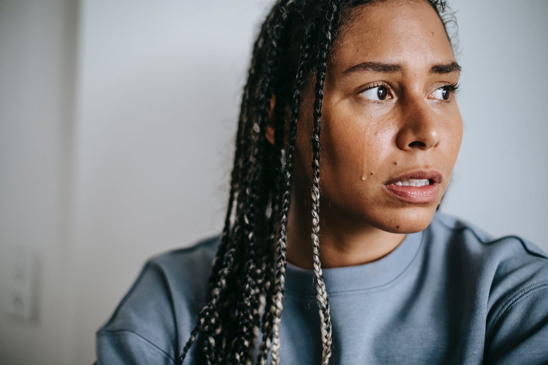 crop sad black woman crying at home